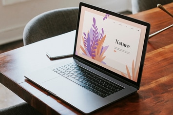 Laptop mockup on a wooden table in a meeting room