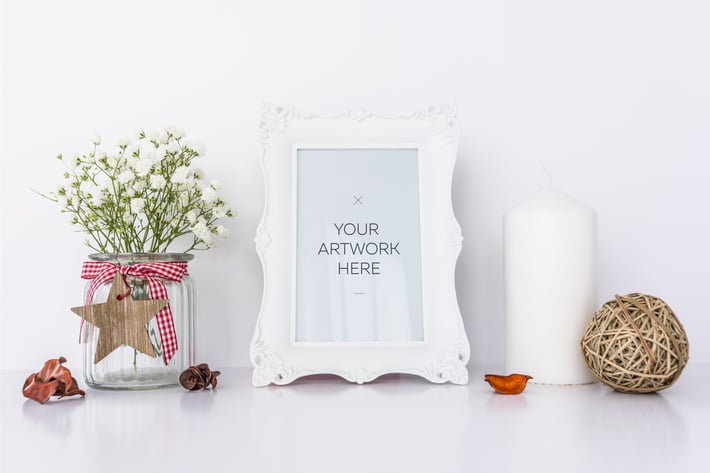 White Frame Mockup with Candle & Flowers