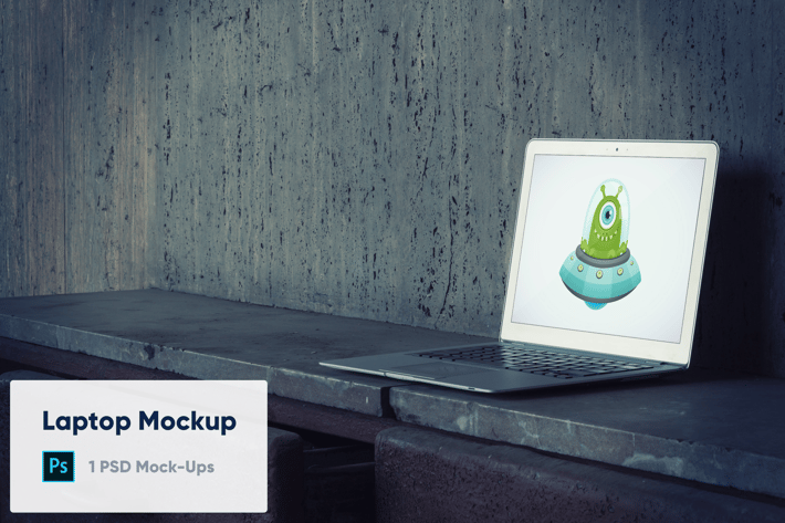 Laptop on Old Concrete Background PSD Mockup