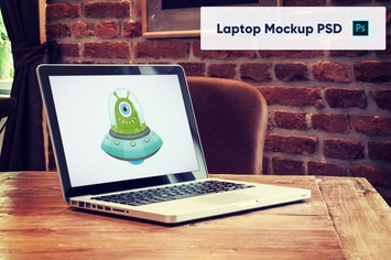 Laptop on Wooden Table in Luxury Cafe - Mockup PSD