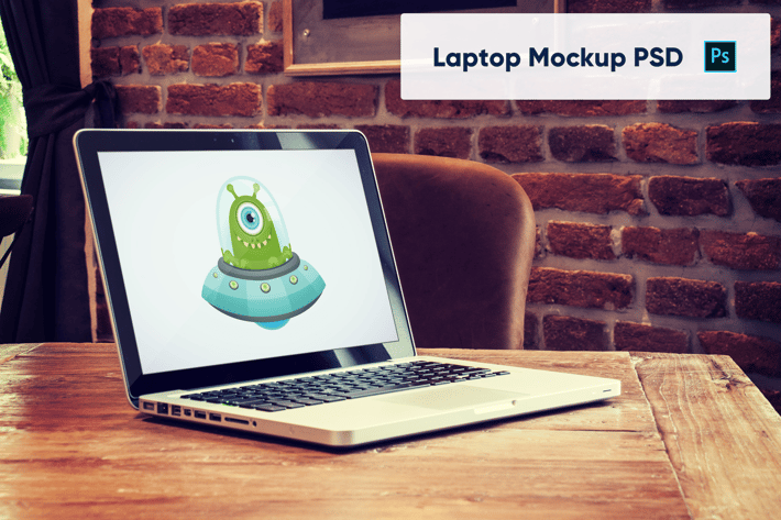 Laptop on Wooden Table in Luxury Cafe - Mockup PSD