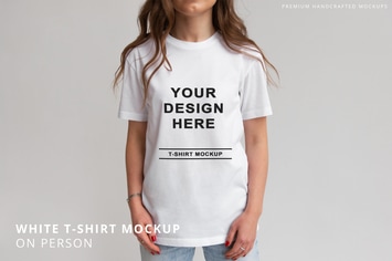 White T-Shirt on Person Mockup Grey Background 