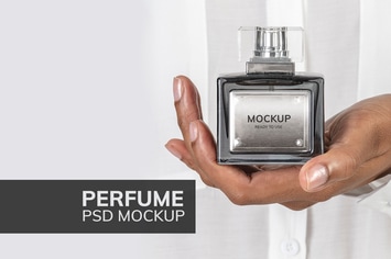 Hands holding blank perfume glass bottle mockup