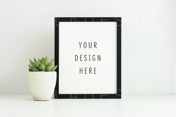 Black picture frame mockup and plant