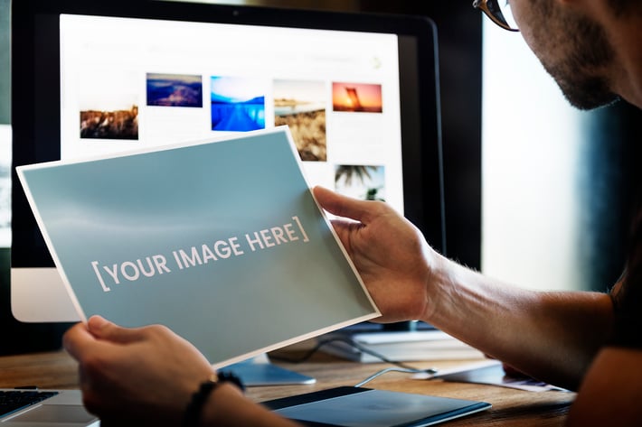 Photographer holding a mockup picture