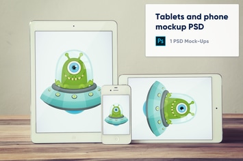 Tablets and phone on wooden background mockup PSD