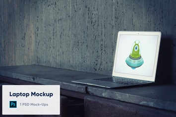 Laptop on Old Concrete Background PSD Mockup