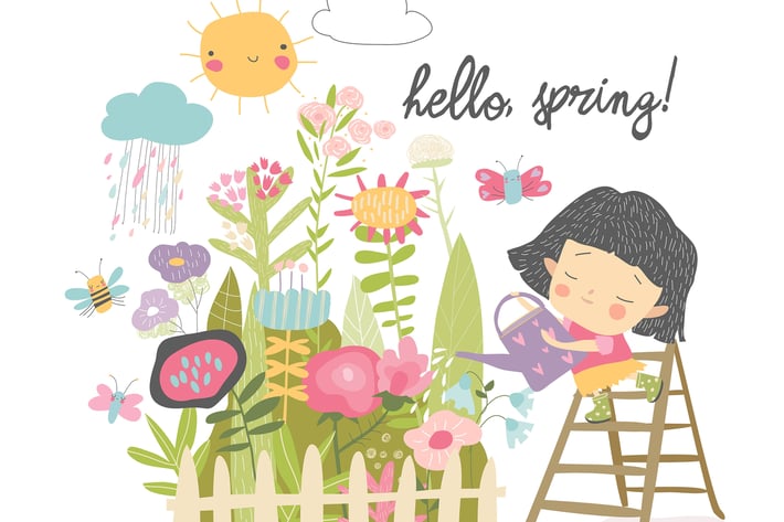 Happy girl watering flowers from a watering can in