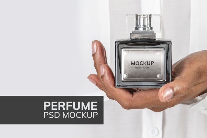Hands holding blank perfume glass bottle mockup