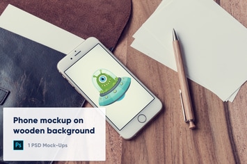 Phone and Blank Paper on Wooden Background Mockup