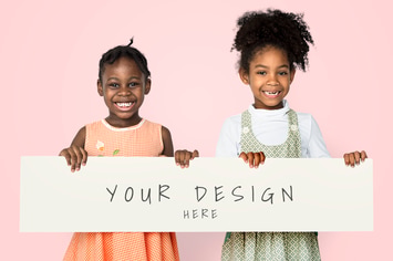 Cheerful little girls holding blank banner mockup