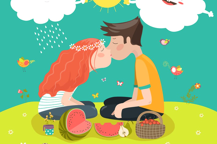 Young couple kissing at a meadow 