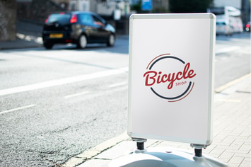 Bicycle shop sign mockup on the street of the city