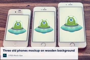 3 old phones mockup on wooden background