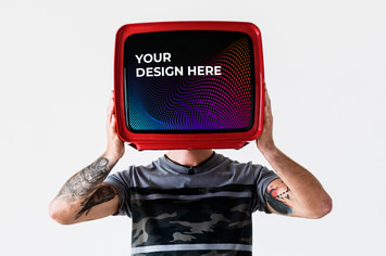Person with tattoo holding television mockup