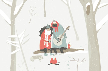 Boy plays guitar for a girl in the winter forest. 
