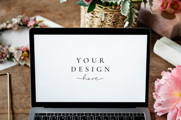 Laptop with Flowers on The Wooden Table