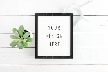 Black picture frame mockup and plant