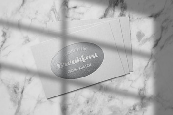 Embossed silver logo mockup on linen paper